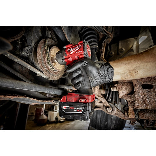 Milwaukee M18 FUEL 3/8" Mid-Torque Impact Wrench 2960-20 in use, red and black tool held by gloved hand working on.