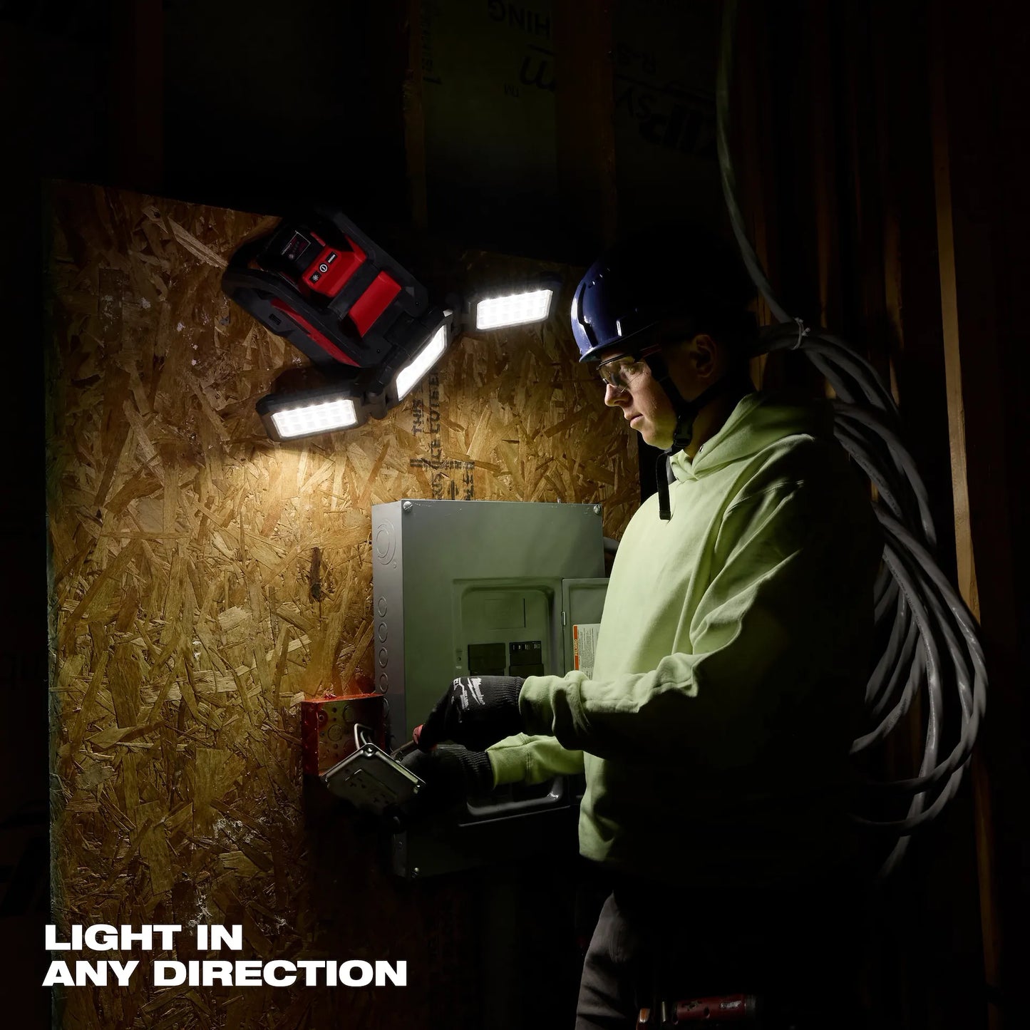 Milwaukee M18™ ROVER™ Dual Power Flood & Area Triple Light 2368-20 illuminating worker with tool panel.