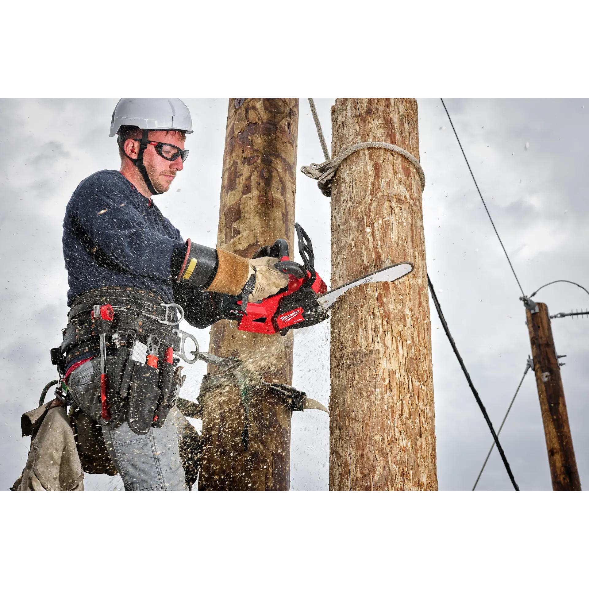 Milwaukee M18 14" Top Handle Chain Saw 2826-20 in use cutting wood, showing red and black tool features.