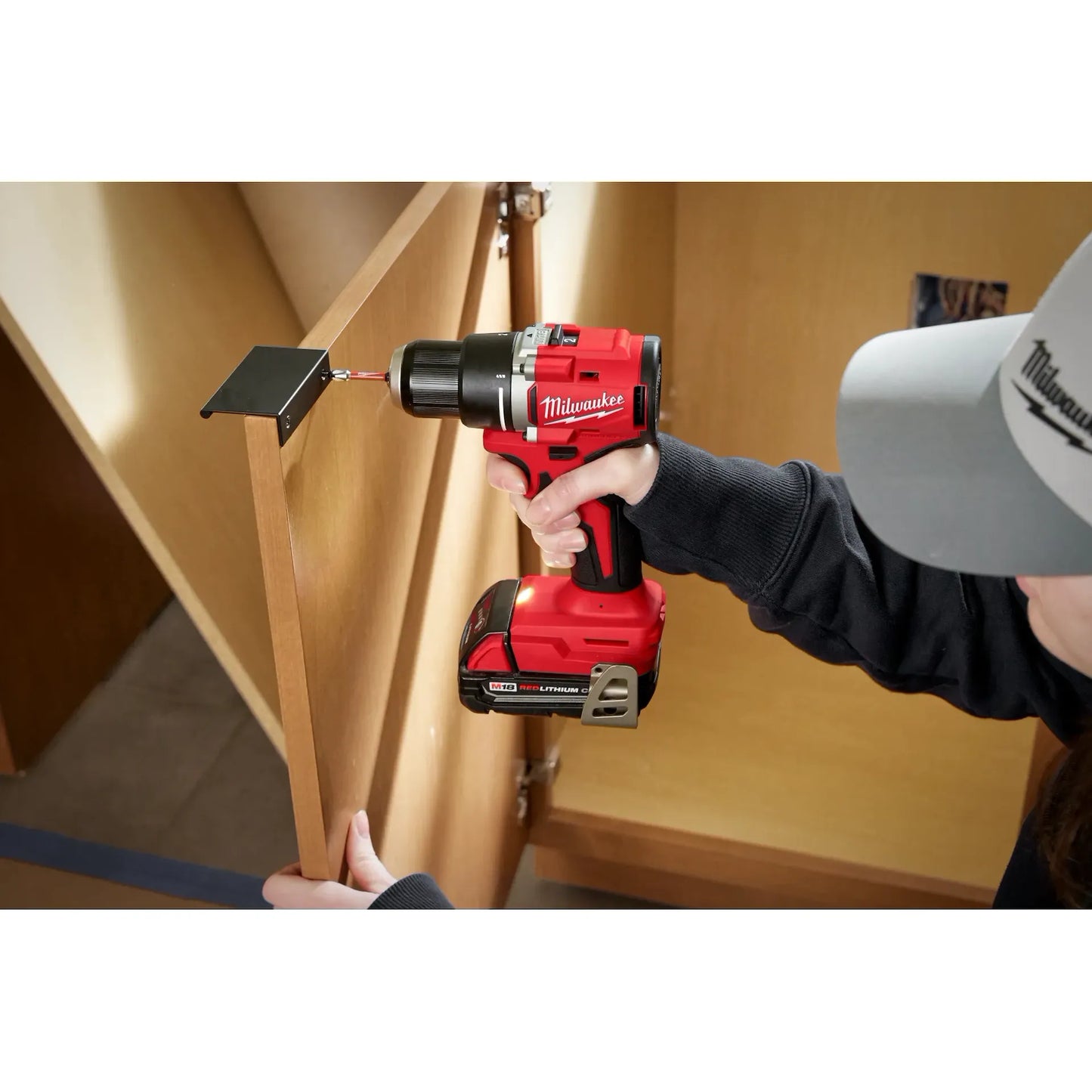 Milwaukee M18 Compact Brushless Drill 3601-20 red and black cordless tool used for woodworking tasks.