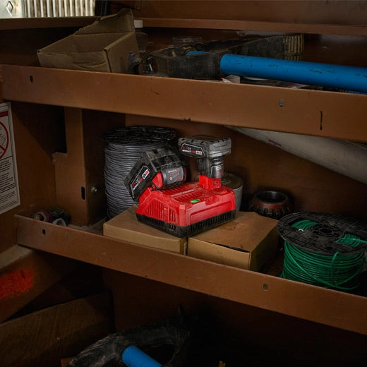 Milwaukee M18/M12 Rapid Charger 48-59-1808 red and black tool charger on shelf with tools nearby.
