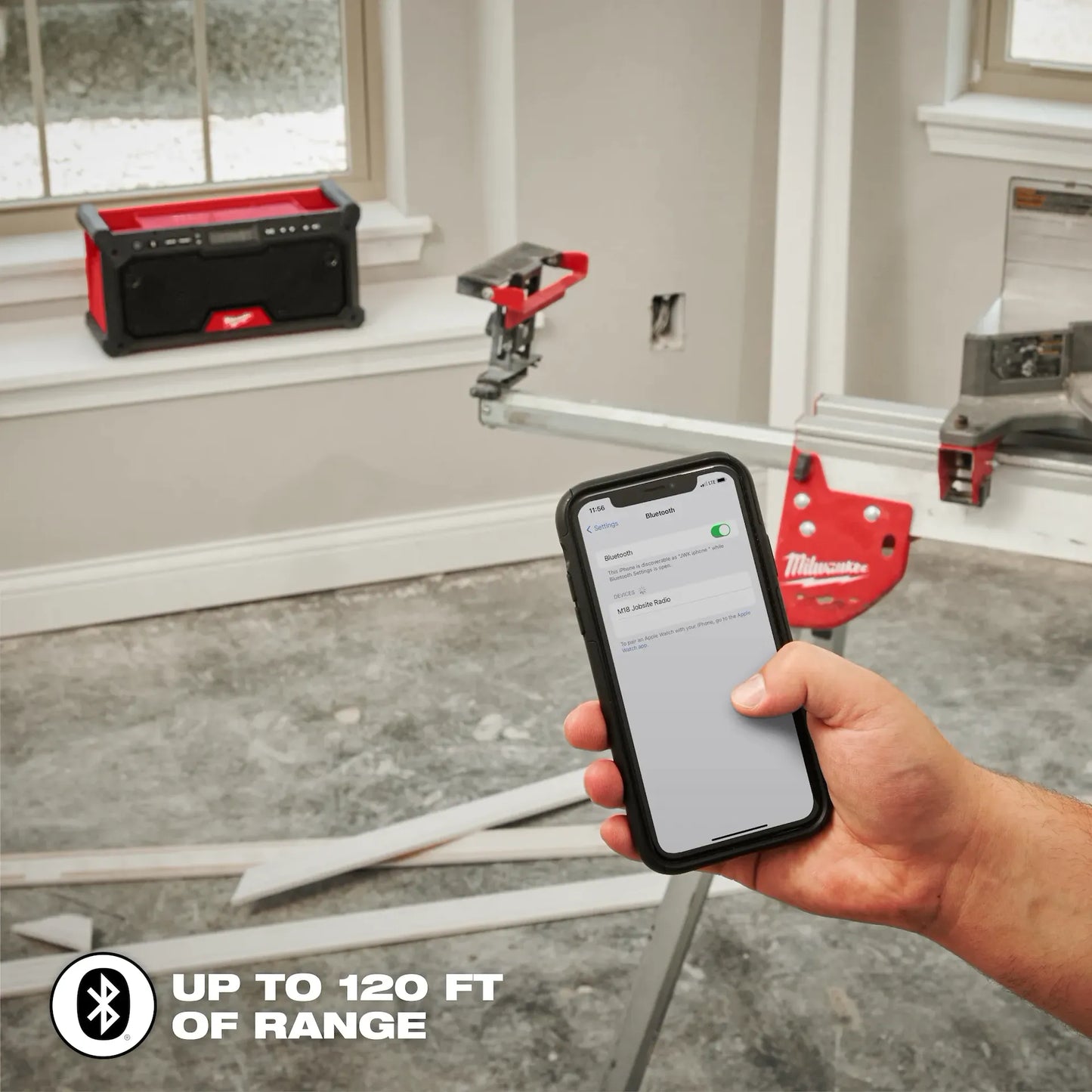 Milwaukee M18™ Bluetooth® Jobsite Radio 2952-20 with handheld smartphone showing Bluetooth connection, portable.