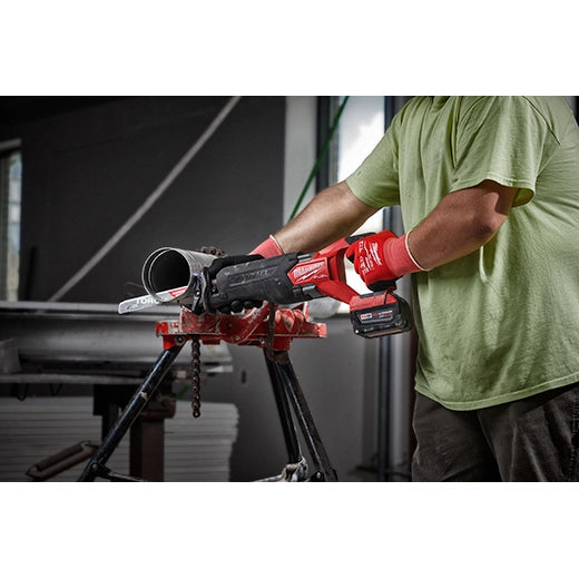 Milwaukee M18 FUEL™ SAWZALL® Recip Saw 2821-20 tool held by worker in green shirt and red gloves cutting metal pipe .
